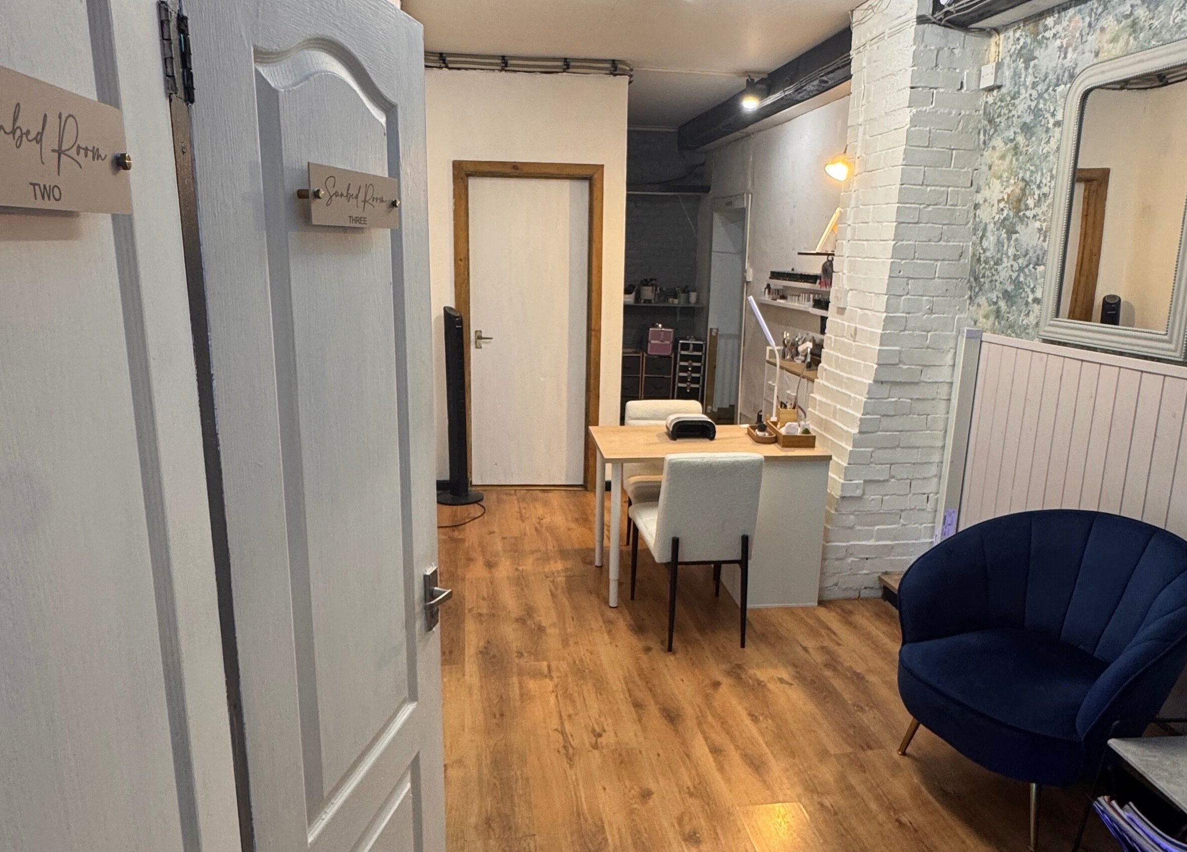 Cozy interior of Glo Tanning & Beauty Salon Newtown, Wales, GB with plush seating and inviting decor.