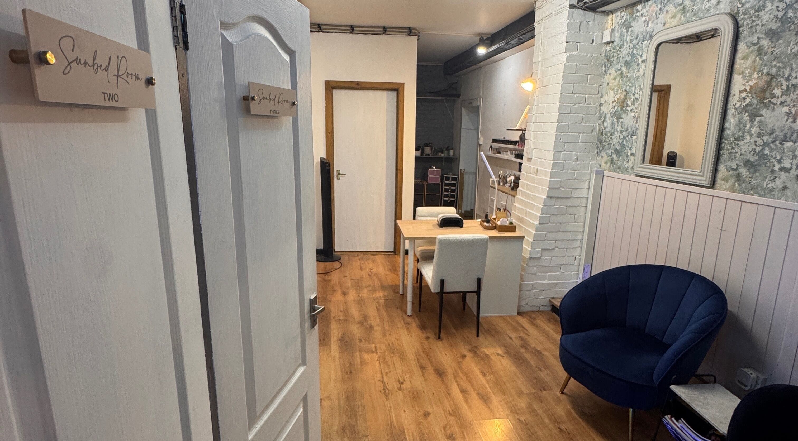 Cozy interior of Glo Tanning & Beauty Salon Newtown, Wales, GB with plush seating and inviting decor.