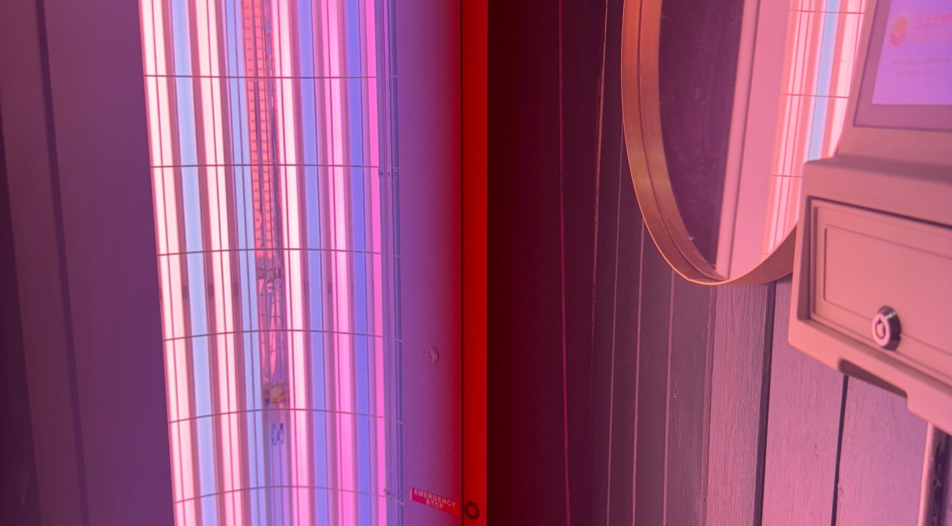 Neon tanning bed at Glo Tanning & Beauty Salon Newtown, Newtown, Wales, GB offering a stylish aesthetic.