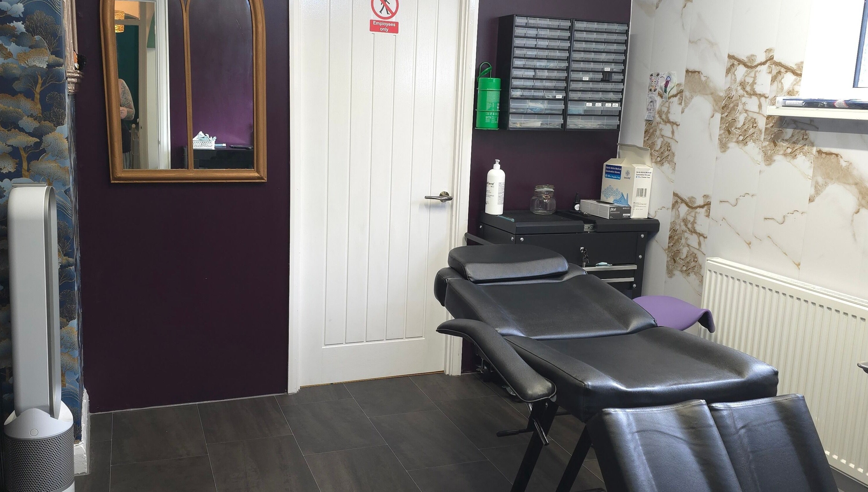 Elegant interior of Labyrinth Piercing Boutique in Grimsby, England, GB with stylish decor and comfortable chair.