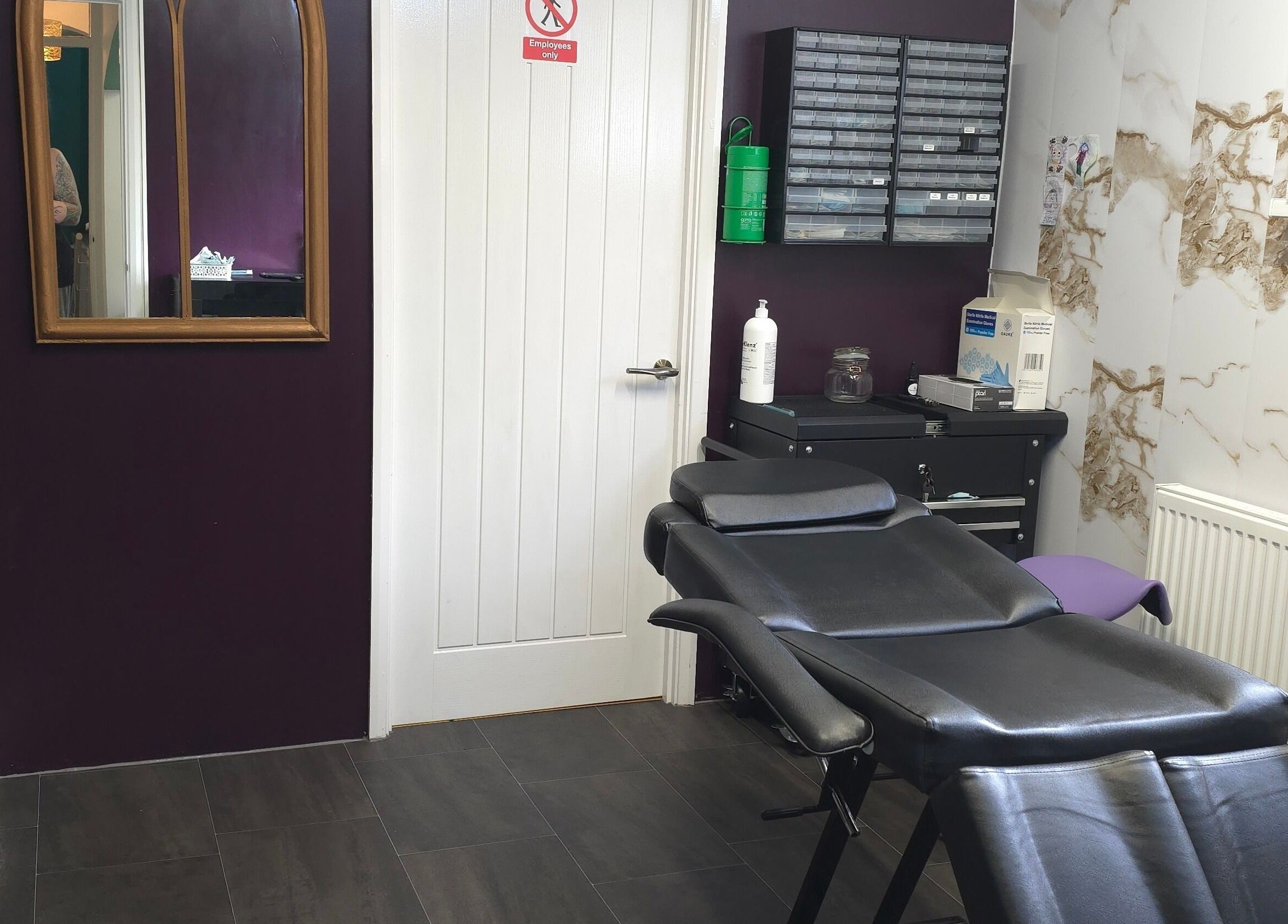 Elegant interior of Labyrinth Piercing Boutique in Grimsby, England, GB with stylish decor and comfortable chair.