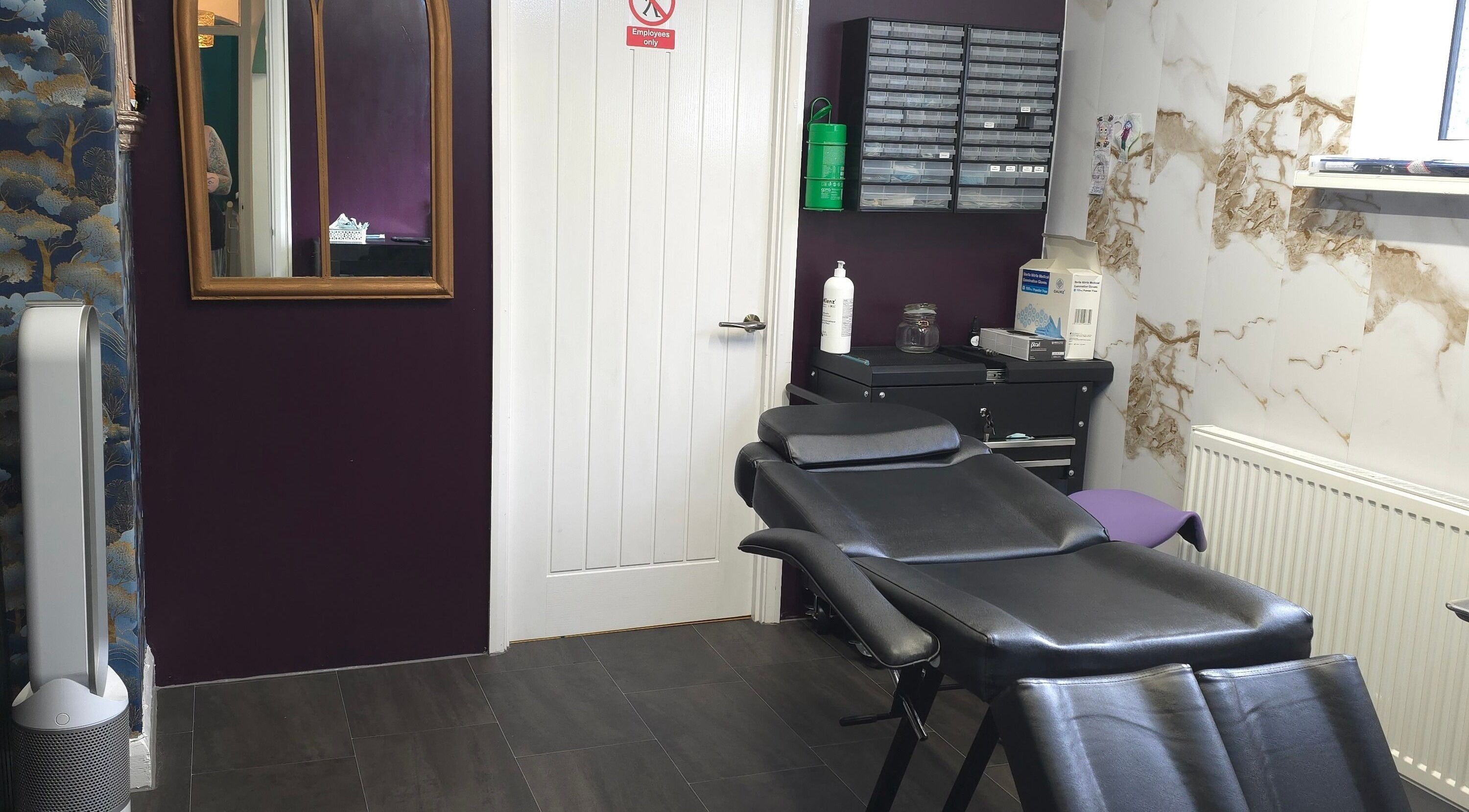Elegant interior of Labyrinth Piercing Boutique in Grimsby, England, GB with stylish decor and comfortable chair.