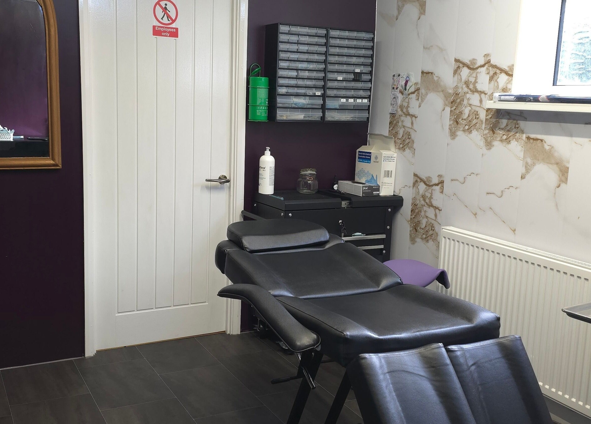 Sophisticated interior of Labyrinth Piercing Boutique, Grimsby, England, GB, showcasing a sleek piercing chair.