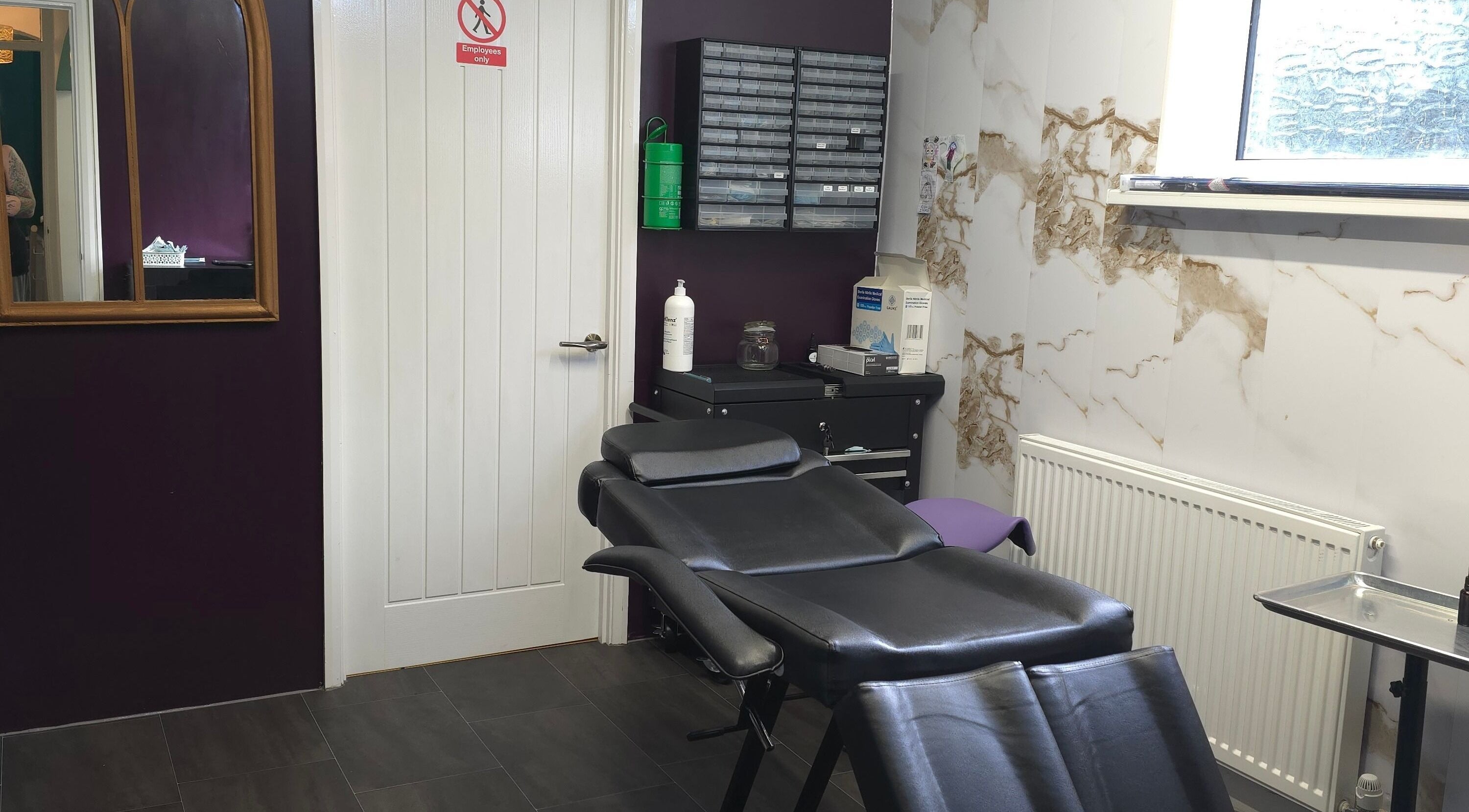 Sophisticated interior of Labyrinth Piercing Boutique, Grimsby, England, GB, showcasing a sleek piercing chair.