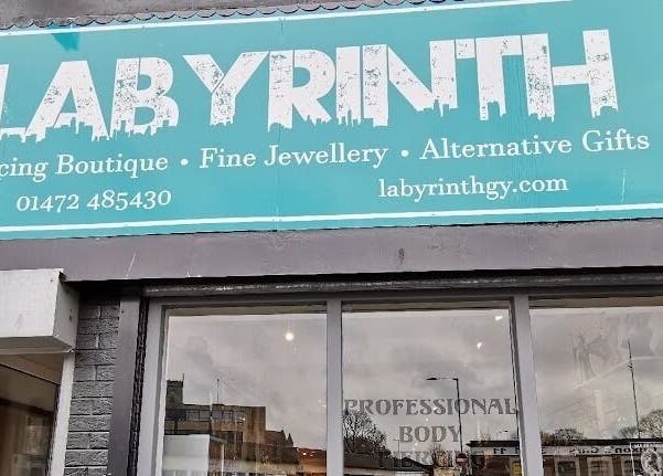 Labyrinth Piercing Boutique exterior sign in Grimsby, England, GB highlighting services and website.
