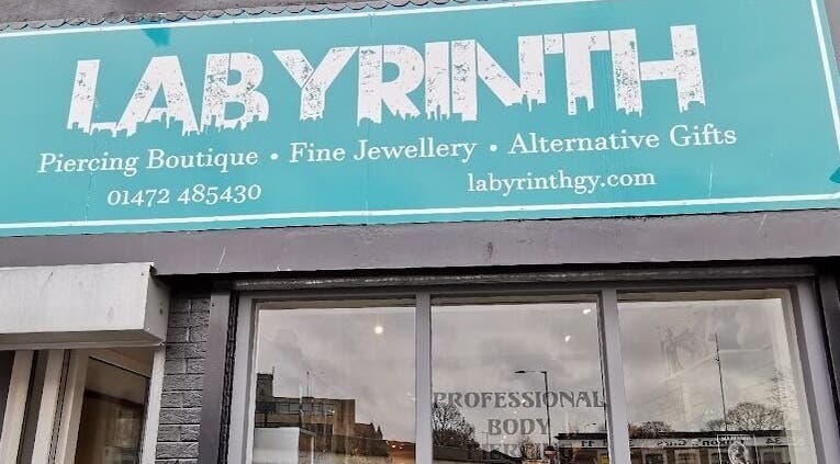 Labyrinth Piercing Boutique exterior sign in Grimsby, England, GB highlighting services and website.