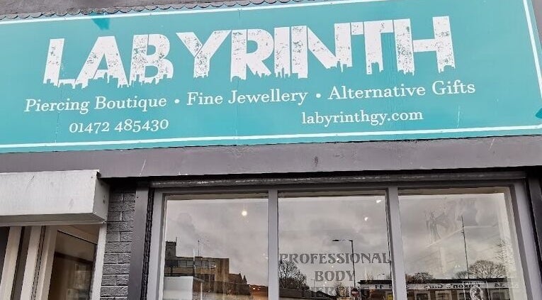 Labyrinth Piercing Boutique exterior sign in Grimsby, England, GB highlighting services and website.