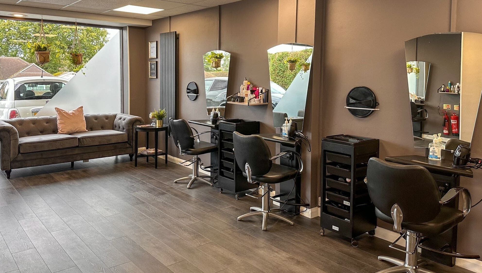 Chic interior of Mane Street Salon LLP, East Grinstead, England, GB featuring stylish seating and workstations.