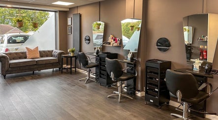 Chic interior of Mane Street Salon LLP, East Grinstead, England, GB featuring stylish seating and workstations.