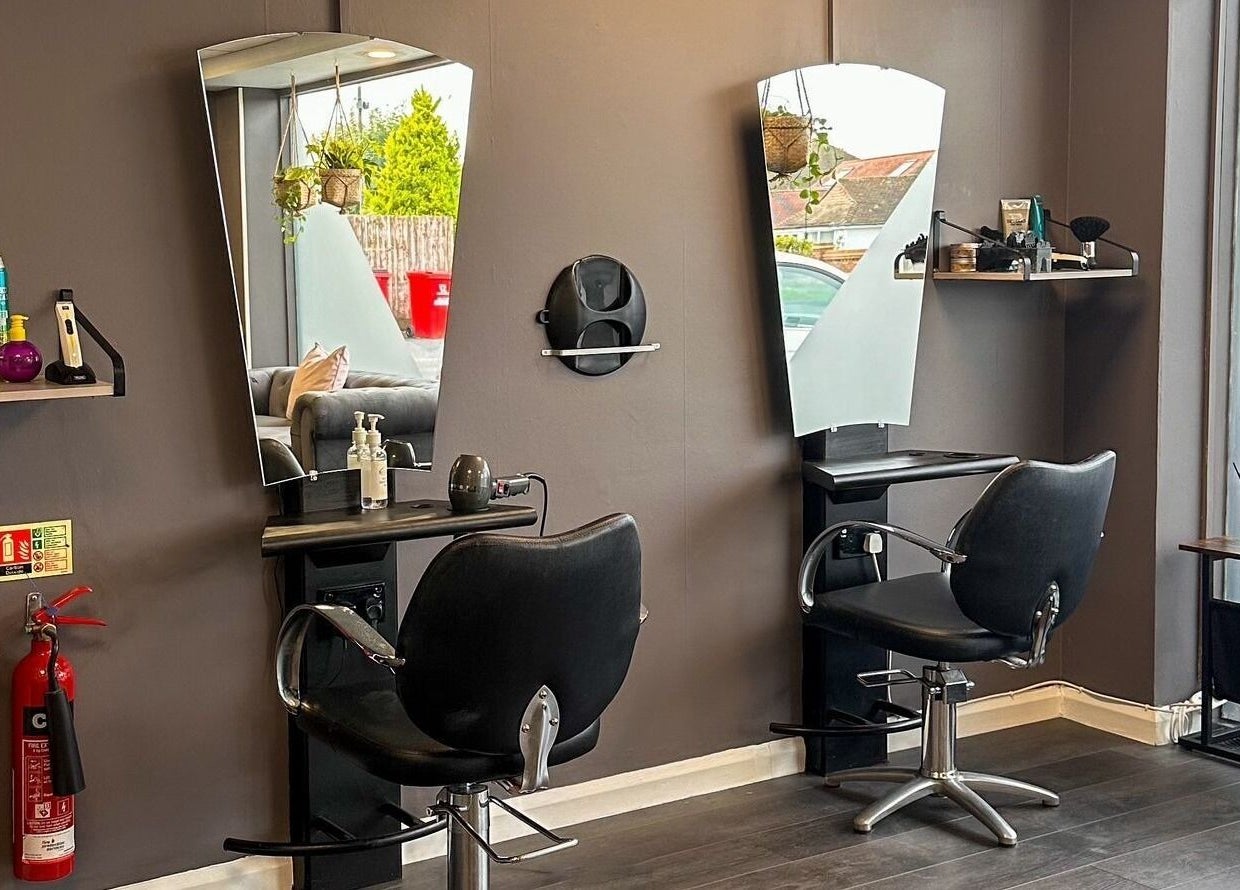 Modern styling station at Mane Street Salon LLP in East Grinstead, England, GB featuring sleek chairs and mirrors.