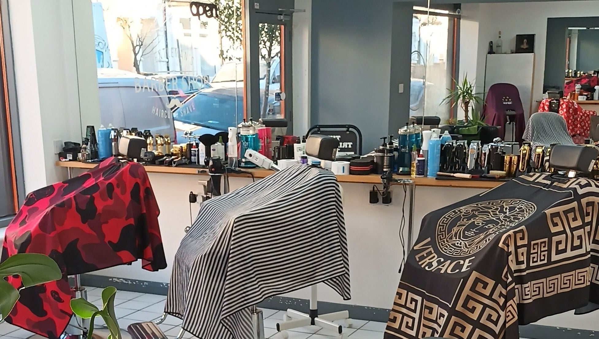 Interior of The Trimmers Wood Green, London, England, GB, featuring stylish barber chairs and grooming tools.