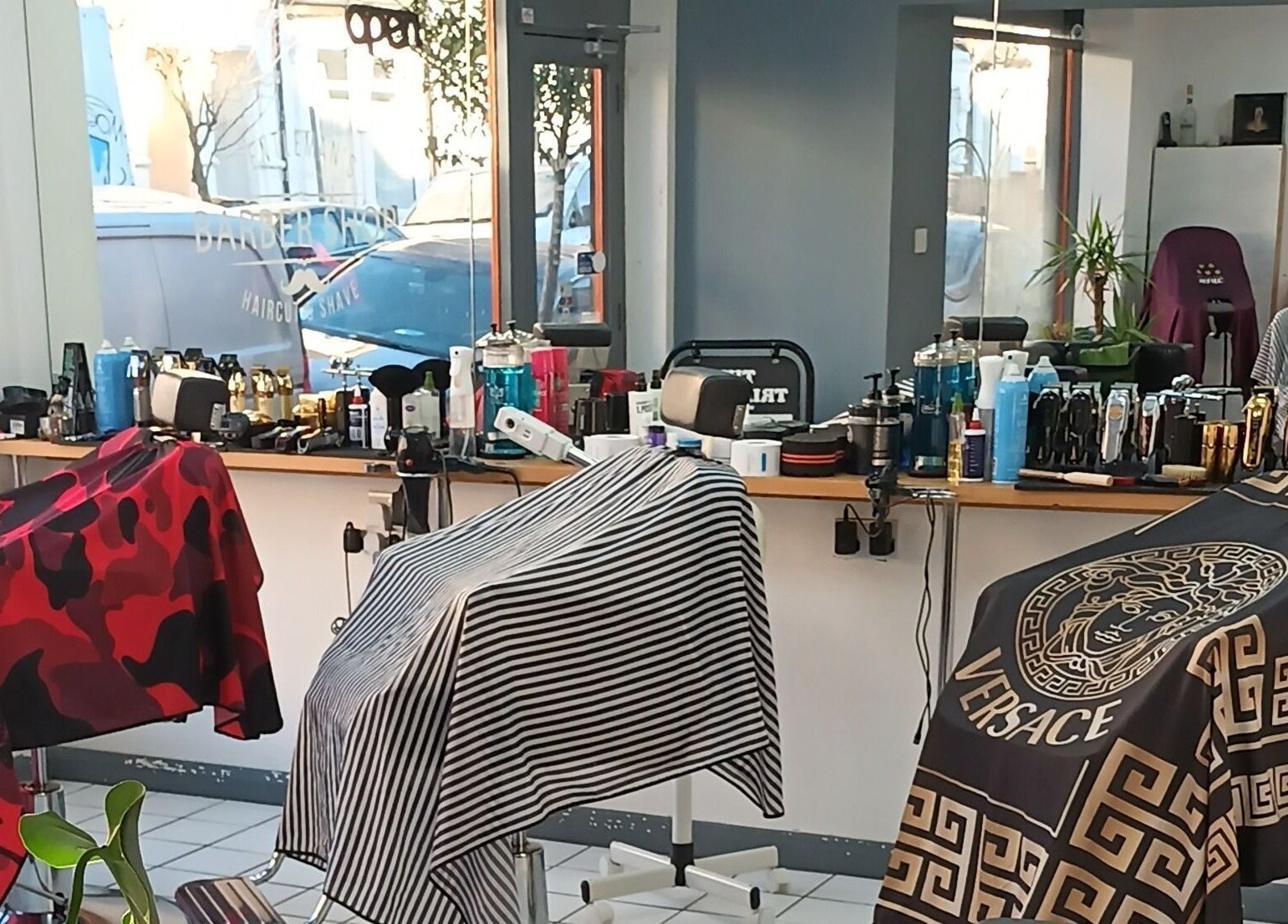 Interior of The Trimmers Wood Green, London, England, GB, featuring stylish barber chairs and grooming tools.