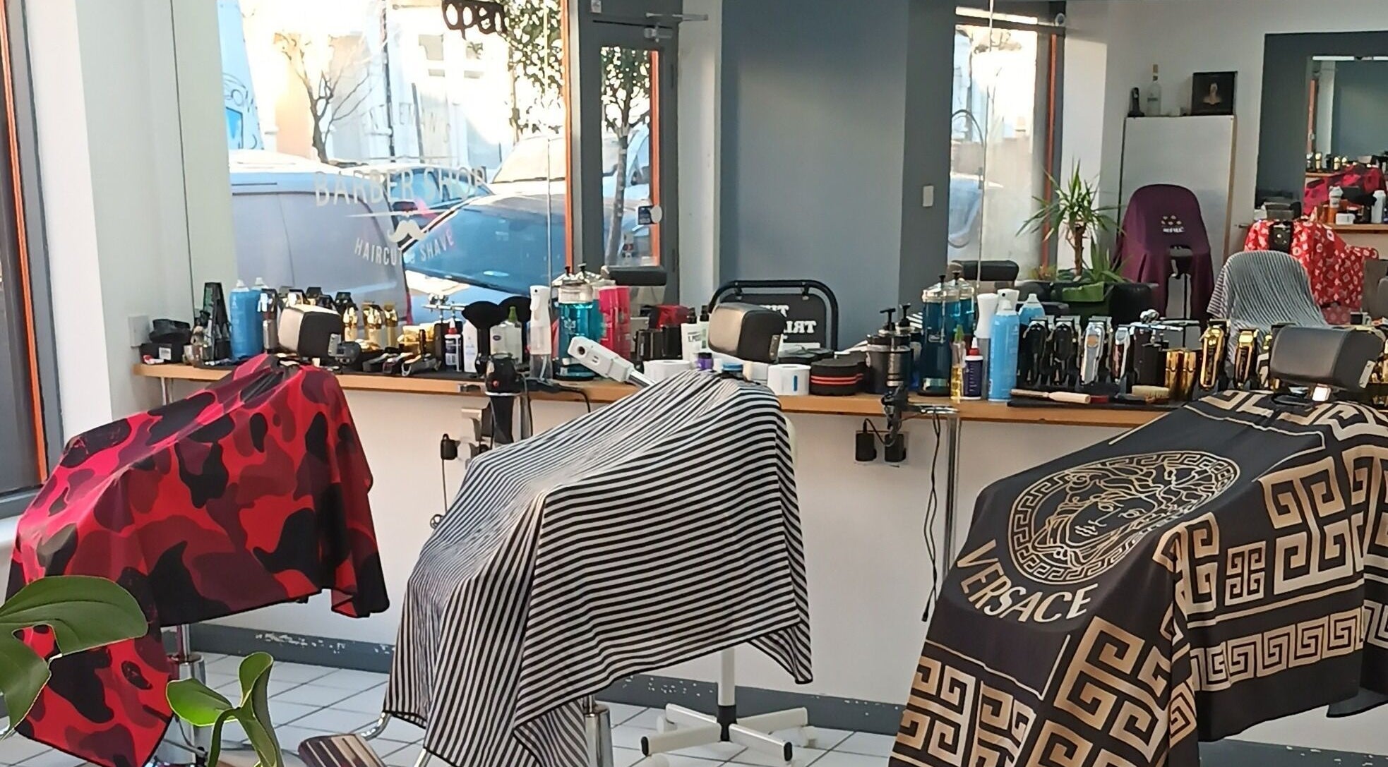 Interior of The Trimmers Wood Green, London, England, GB, featuring stylish barber chairs and grooming tools.