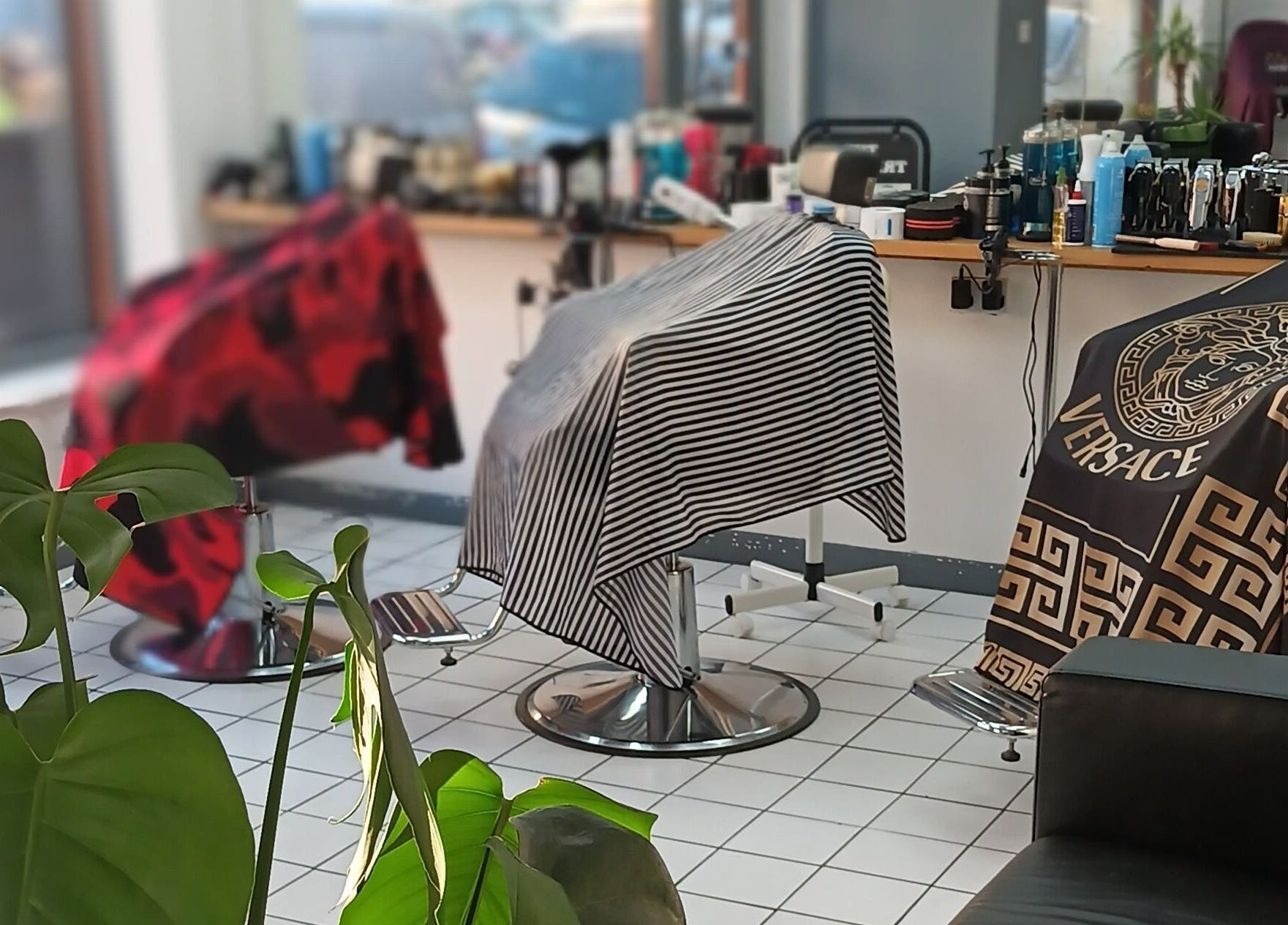 Chic interior of The Trimmers Wood Green in London, England with modern salon chairs and decor.