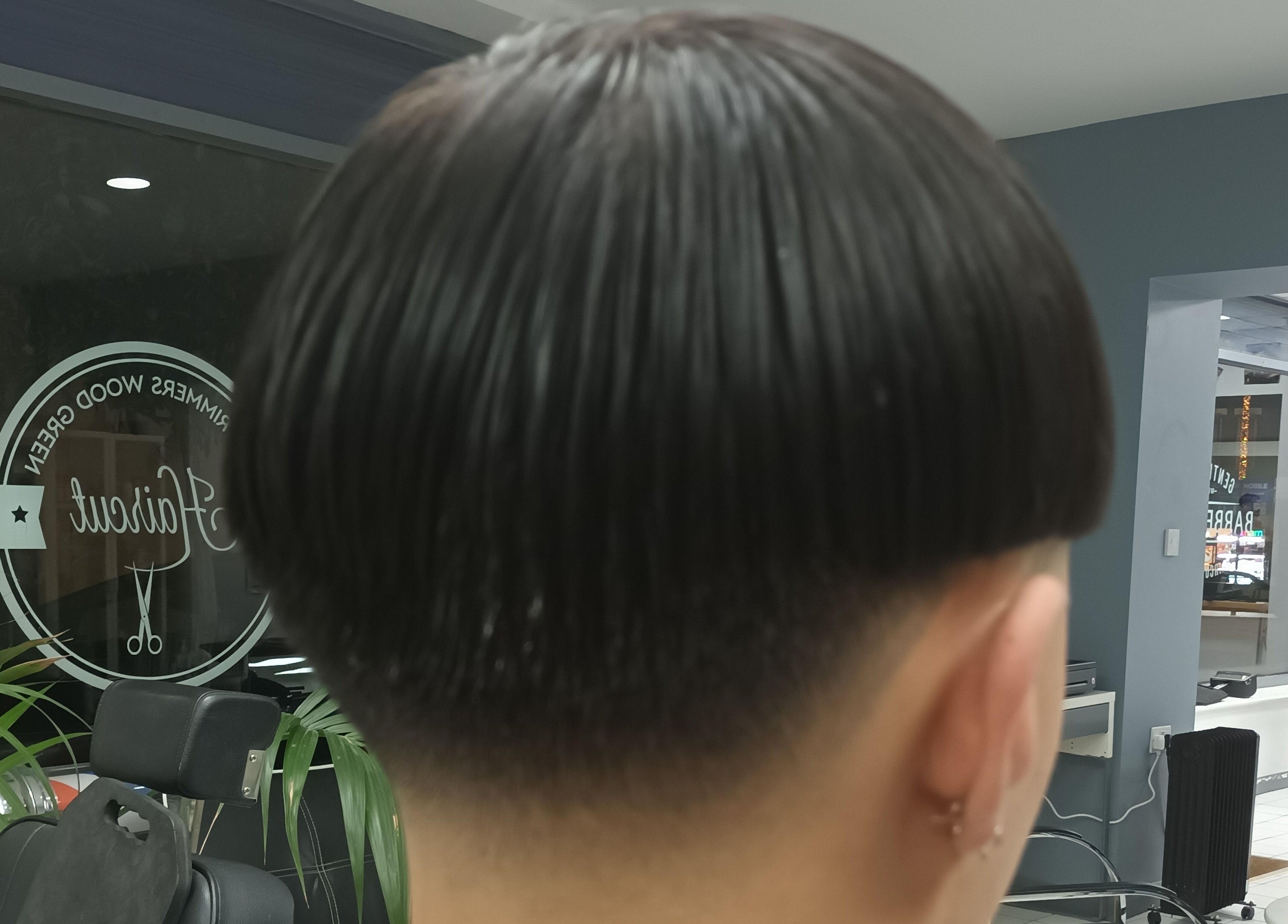 Stylish haircut at The Trimmers Wood Green salon in London, England, GB, showcasing sleek modern style.