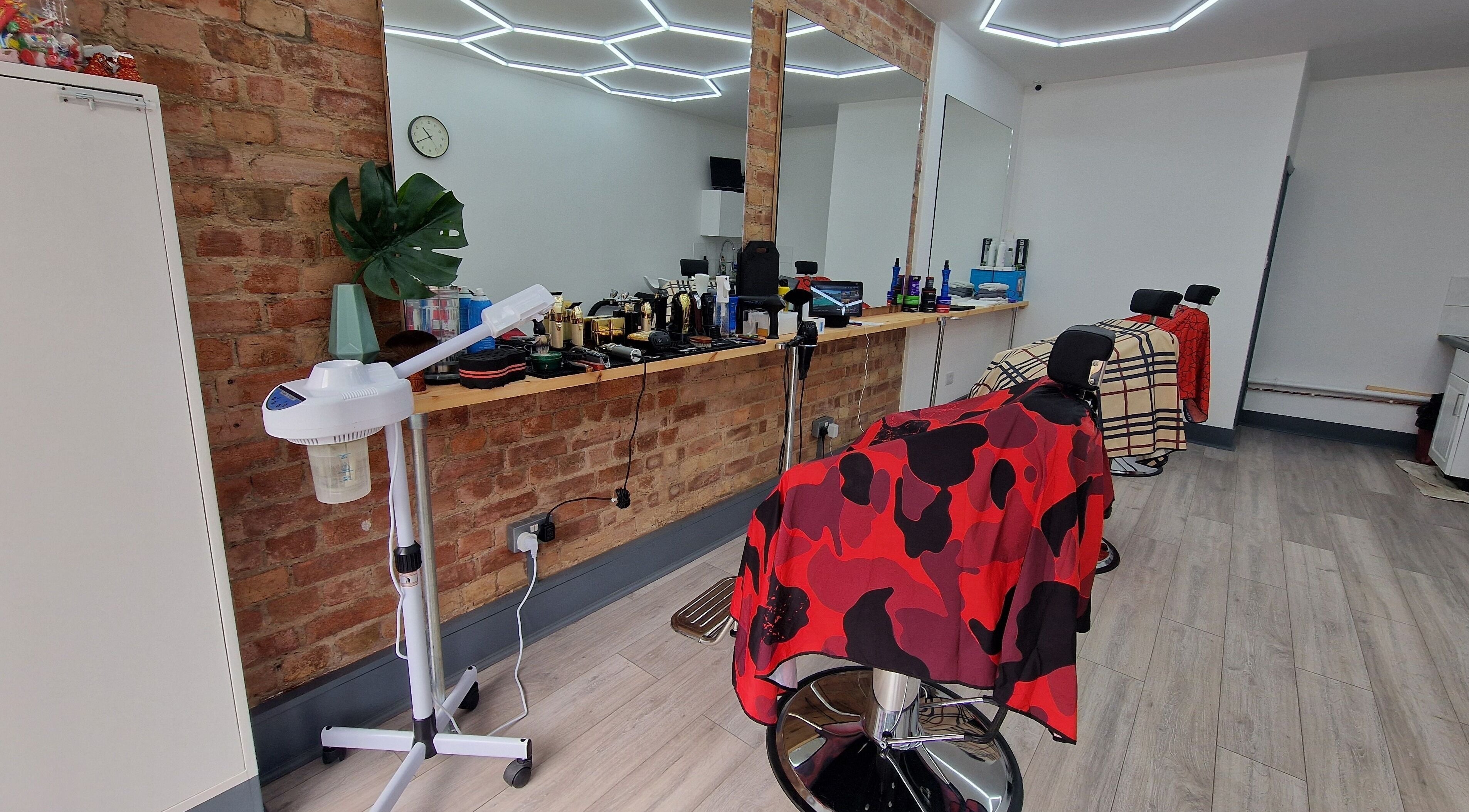 Interior of Fade Hair Hornsey in London, England GB. Modern salon with barbershop chairs and sleek design.