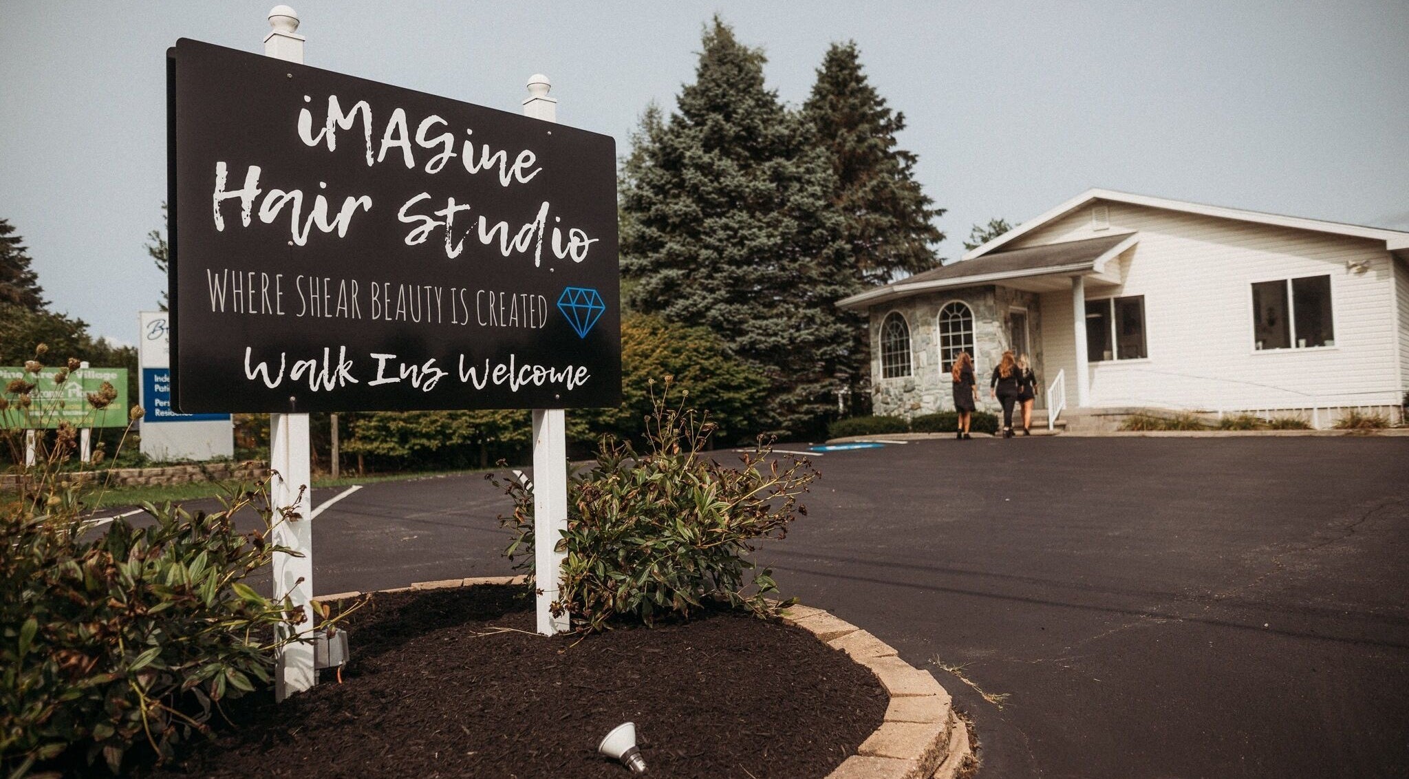 Welcome sign for iMAGine Hair Studio in Brookville, Pennsylvania, US, inviting visitors to the entrance.
