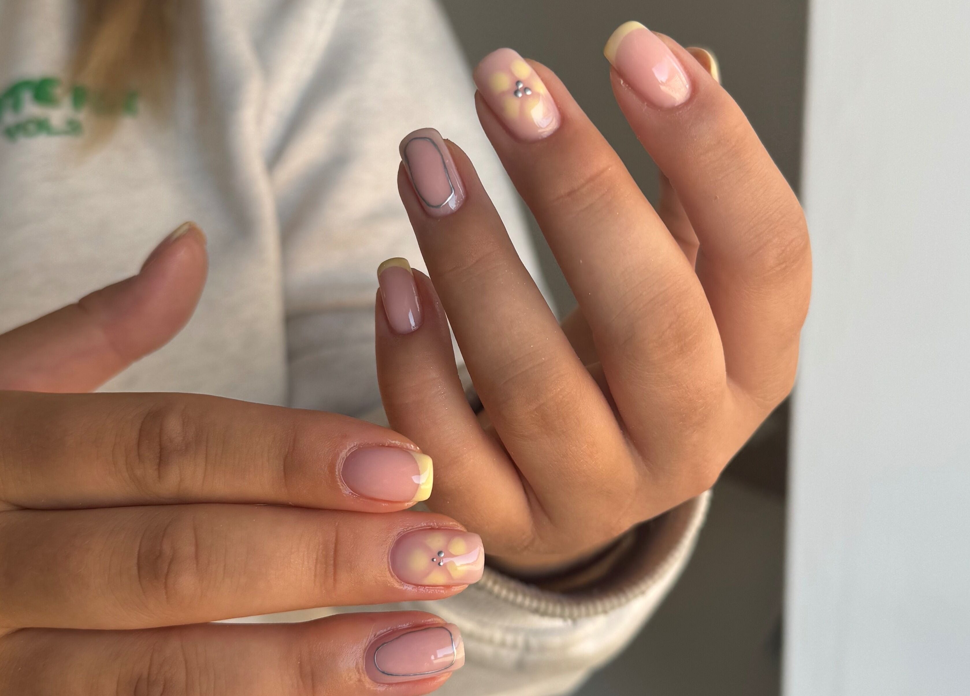 Stylish manicured nails at Painted by Jade in Newtown, Wales, GB showcasing intricate nail art designs.