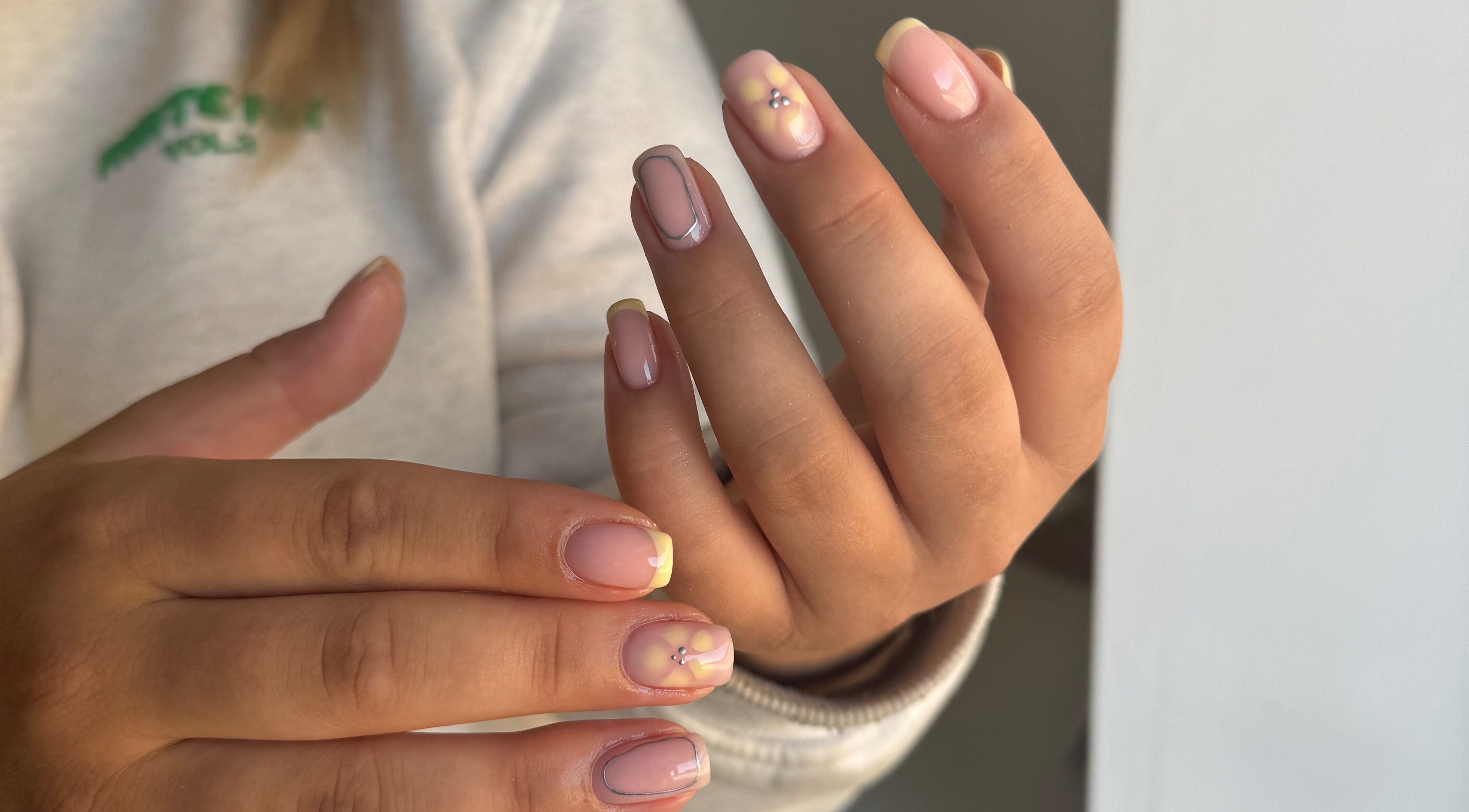 Stylish manicured nails at Painted by Jade in Newtown, Wales, GB showcasing intricate nail art designs.