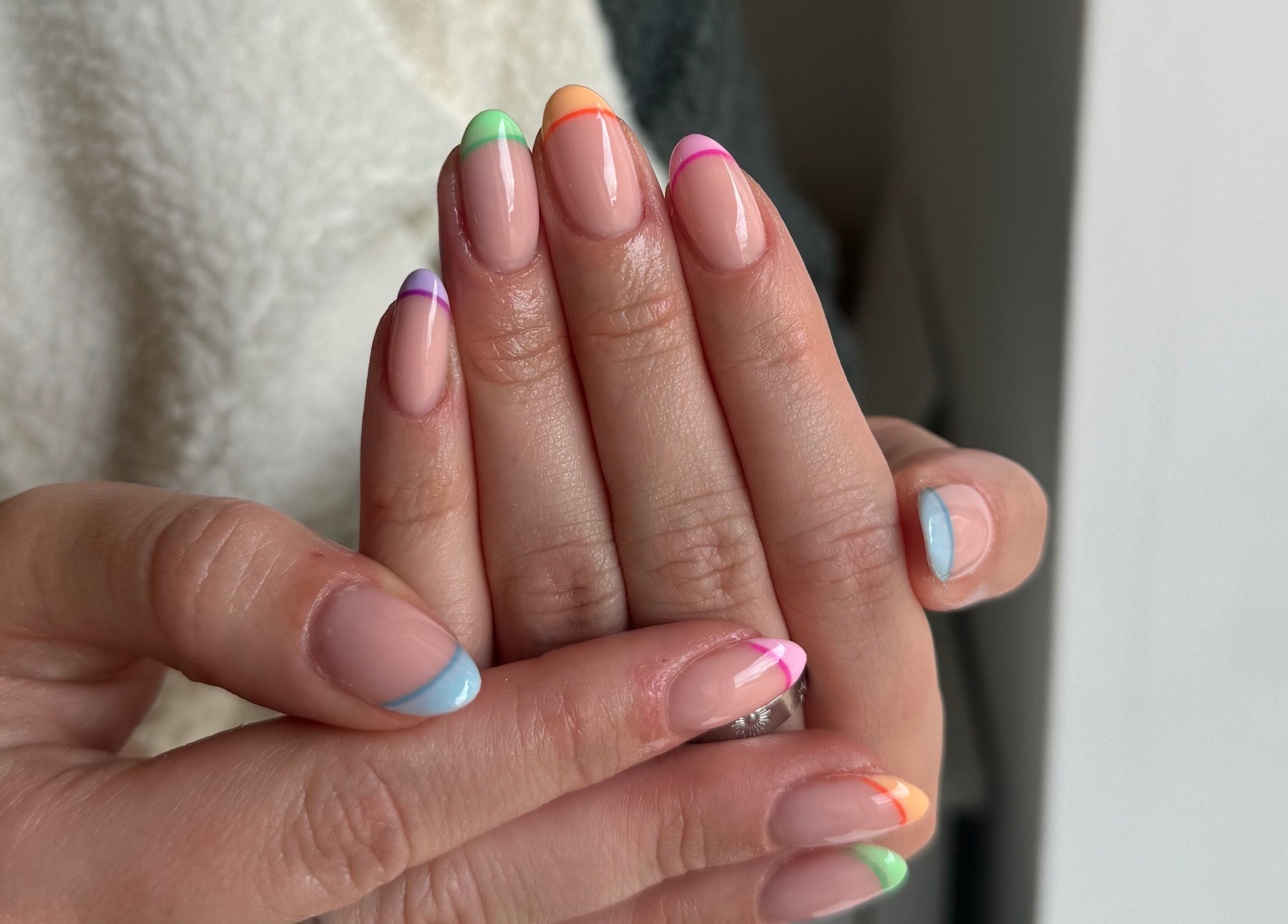 Vibrant rainbow manicure at Painted by Jade, Newtown, Wales, GB showcasing colorful nail art.