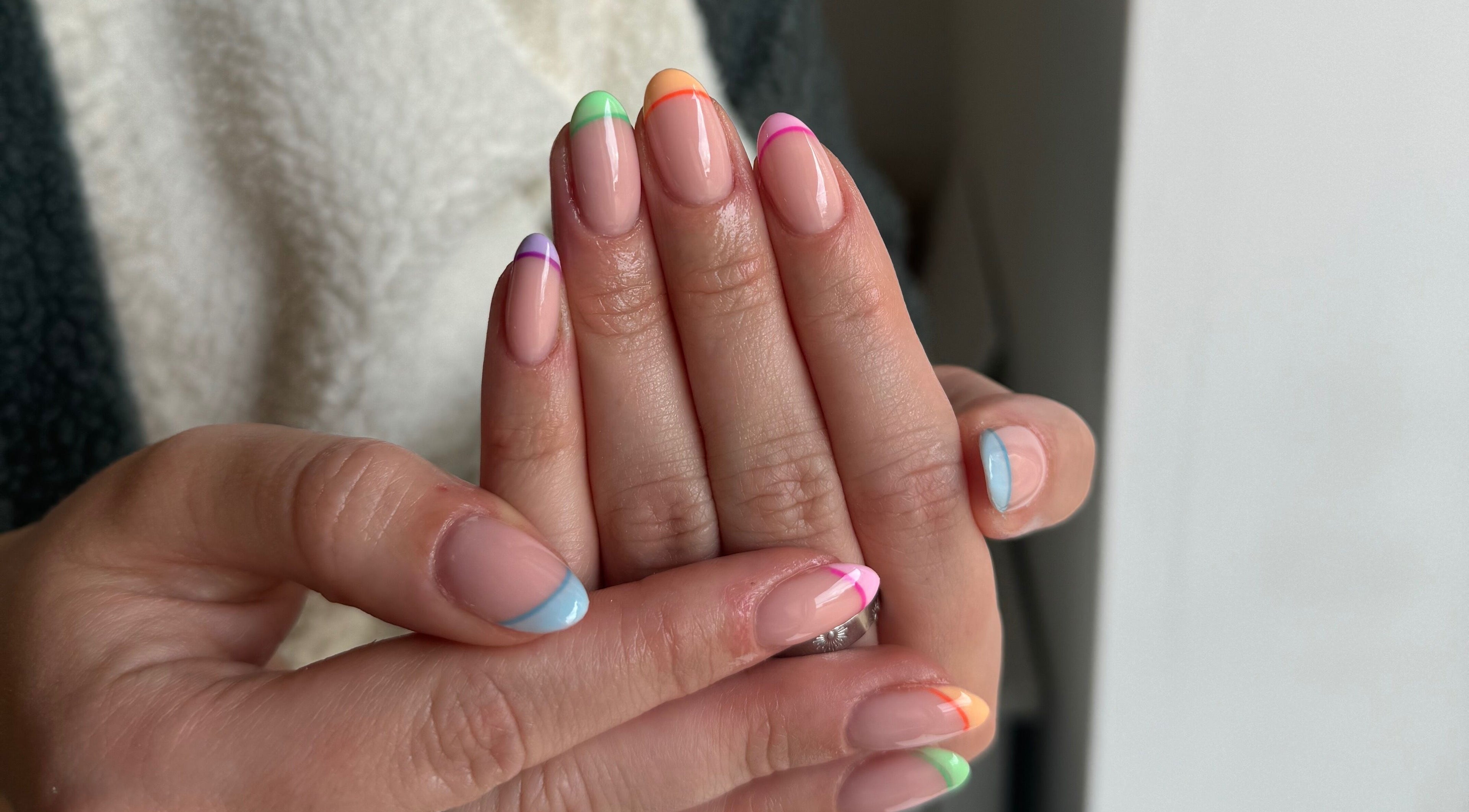 Vibrant rainbow manicure at Painted by Jade, Newtown, Wales, GB showcasing colorful nail art.