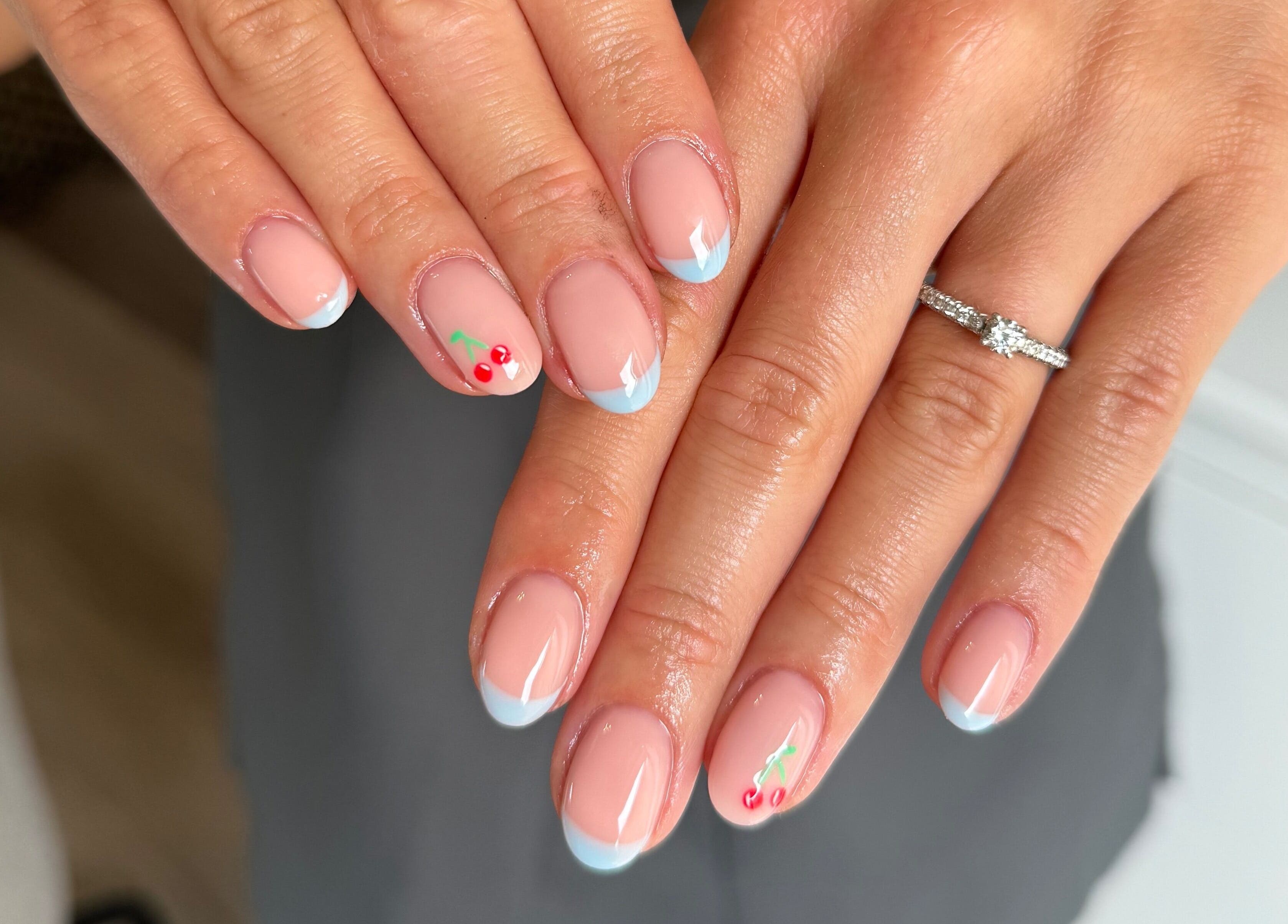 Elegant nail art with cherry details at Painted by Jade, Newtown, Wales, GB.