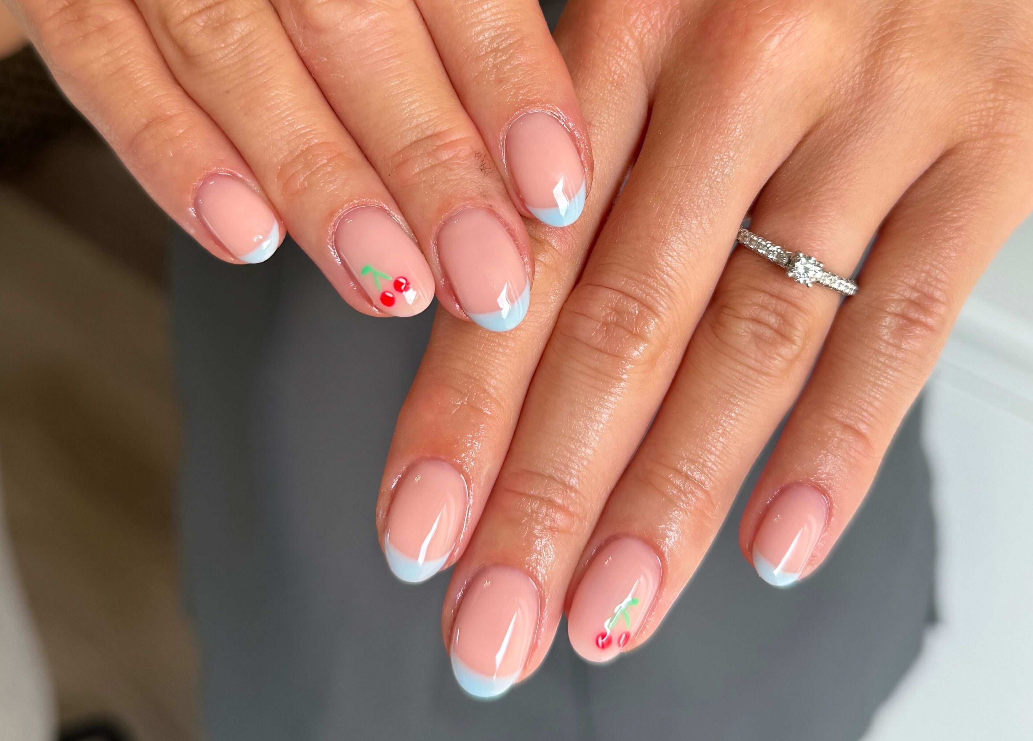 Elegant nail art with cherry details at Painted by Jade, Newtown, Wales, GB.