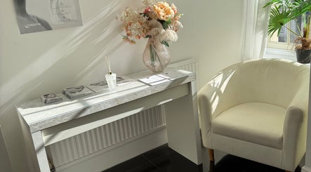 Elegant reception area at MBA Aesthetics & Training, Southampton, England, GB with flowers and modern decor.