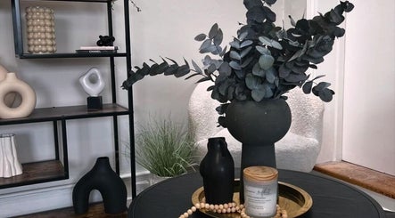 Elegant decor at Upperhand Beauty, Ampthill, GB. Features chic vase, candle, and modern shelf design.