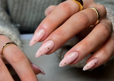Elegant nail art design at Upperhand Beauty, Ampthill, GB. Perfectly manicured hands with gold star accents.