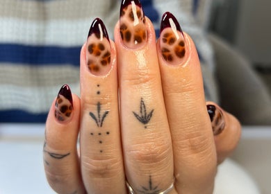 Decorative leopard print nails at Upperhand Beauty, Ampthill, GB, showcasing intricate nail art design.