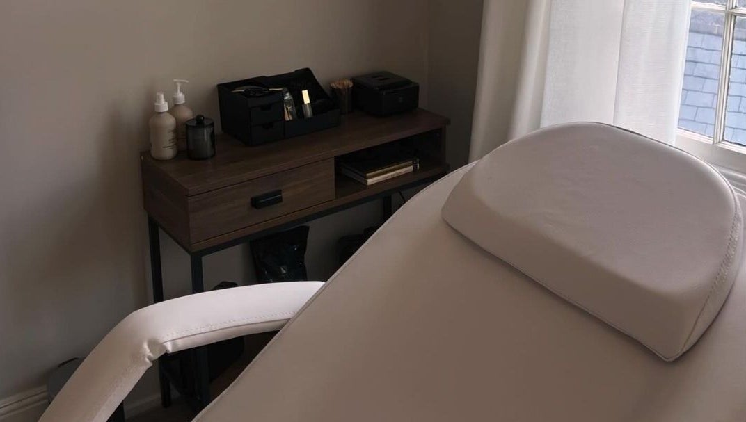Relaxing spa room at Upperhand Beauty, Ampthill, GB featuring a massage bed and grooming essentials.