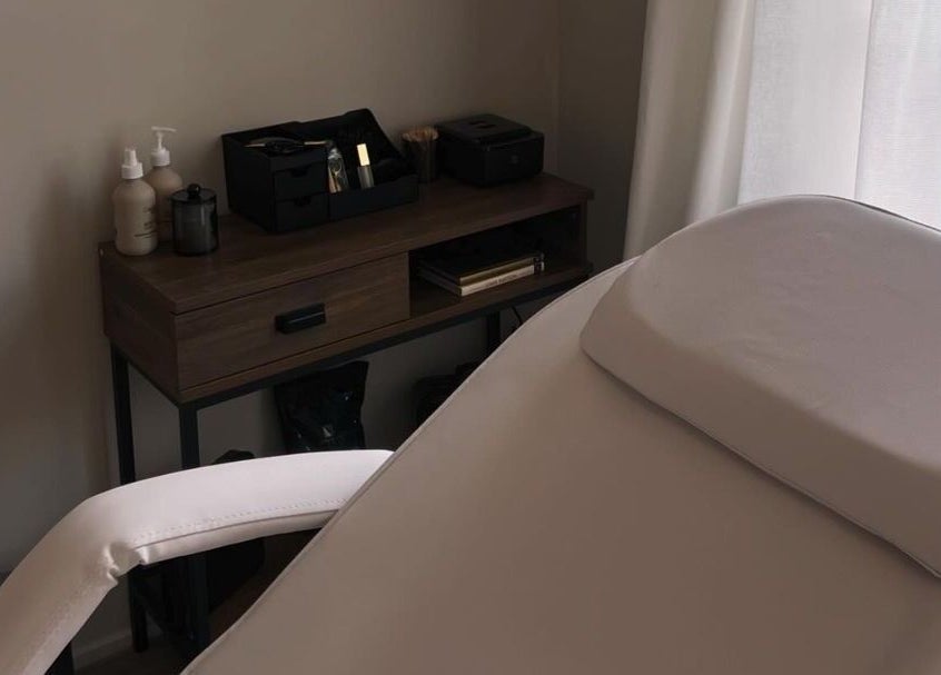 Relaxing spa room at Upperhand Beauty, Ampthill, GB featuring a massage bed and grooming essentials.