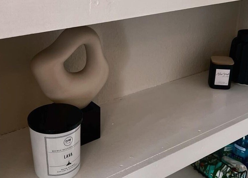 Elegant shelf display with modern decor at Upperhand Beauty in Ampthill, GB, enhancing a tranquil atmosphere.