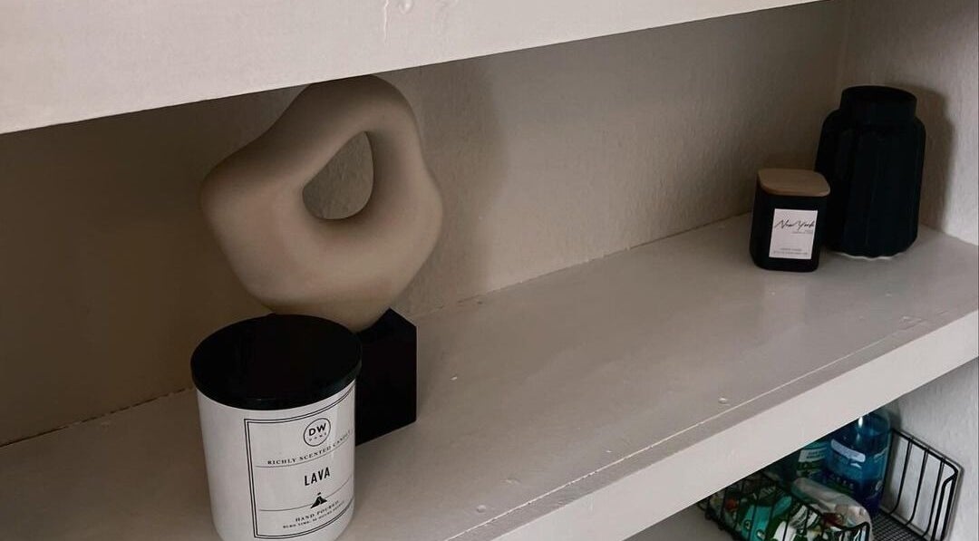 Elegant shelf display with modern decor at Upperhand Beauty in Ampthill, GB, enhancing a tranquil atmosphere.