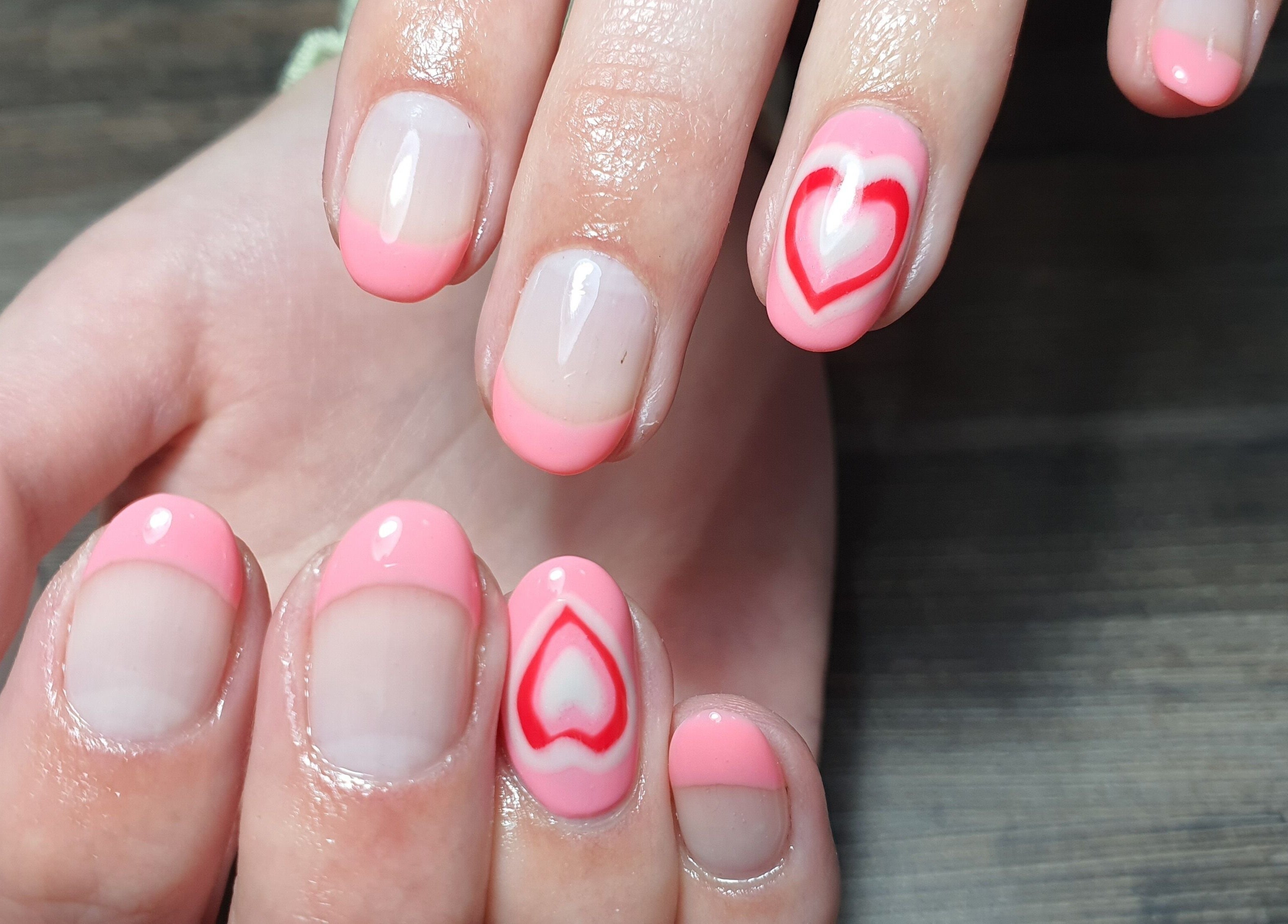 Elegant pink manicure with heart design at Get Nailed Beauty Salon in Bloemfontein, Free State, ZA.
