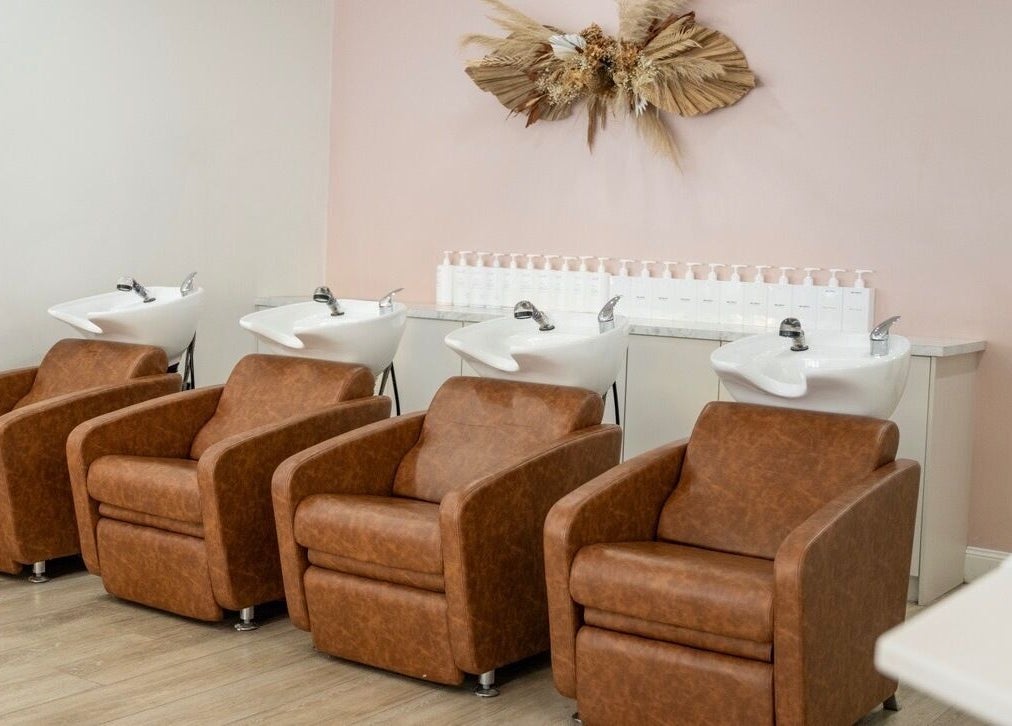 Spacious shampoo lounge at Black Foxx Hair and Beauty, Charlestown, New South Wales, featuring plush chairs.