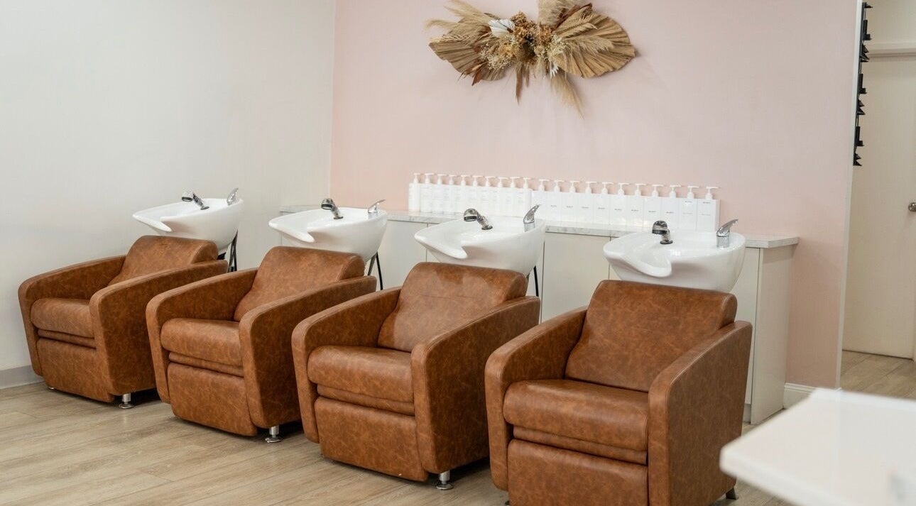 Spacious shampoo lounge at Black Foxx Hair and Beauty, Charlestown, New South Wales, featuring plush chairs.