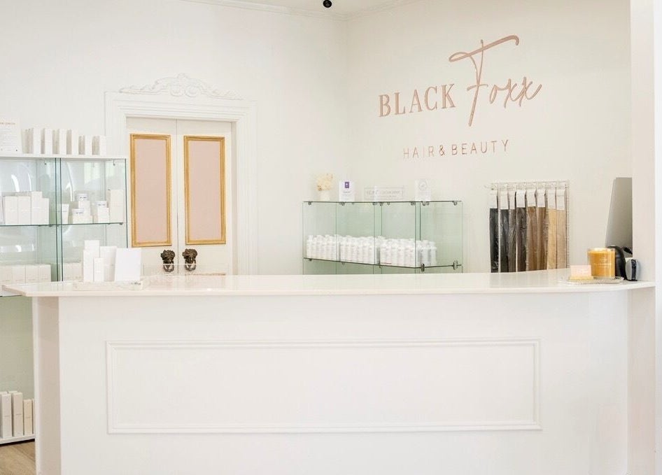 Reception area of Black Foxx Hair and Beauty in Charlestown, New South Wales, AU, showcasing sleek decor.