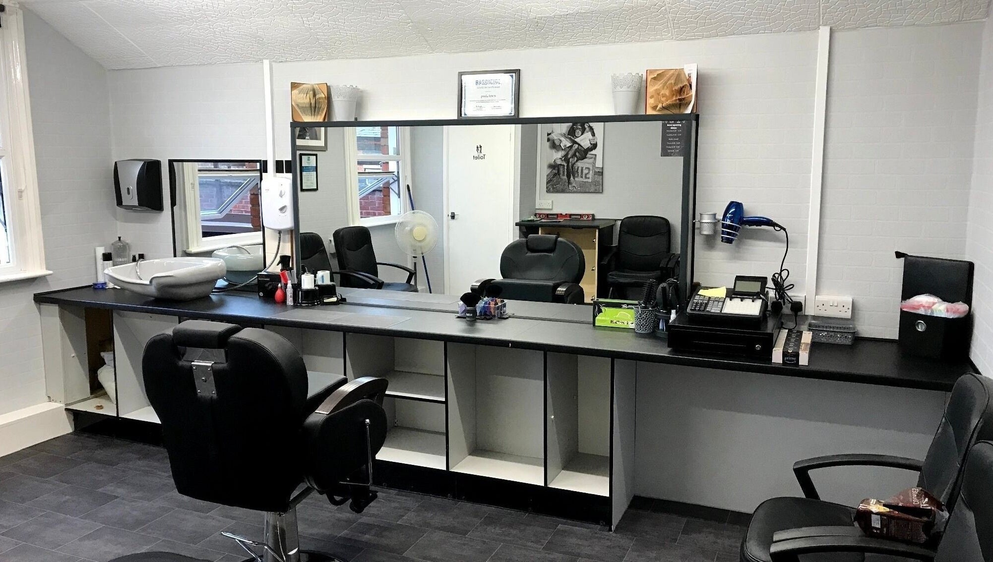 Contemporary barber chairs and stations at 3 Of A Kind Barbers in Malvern, England, GB offering stylish grooming.