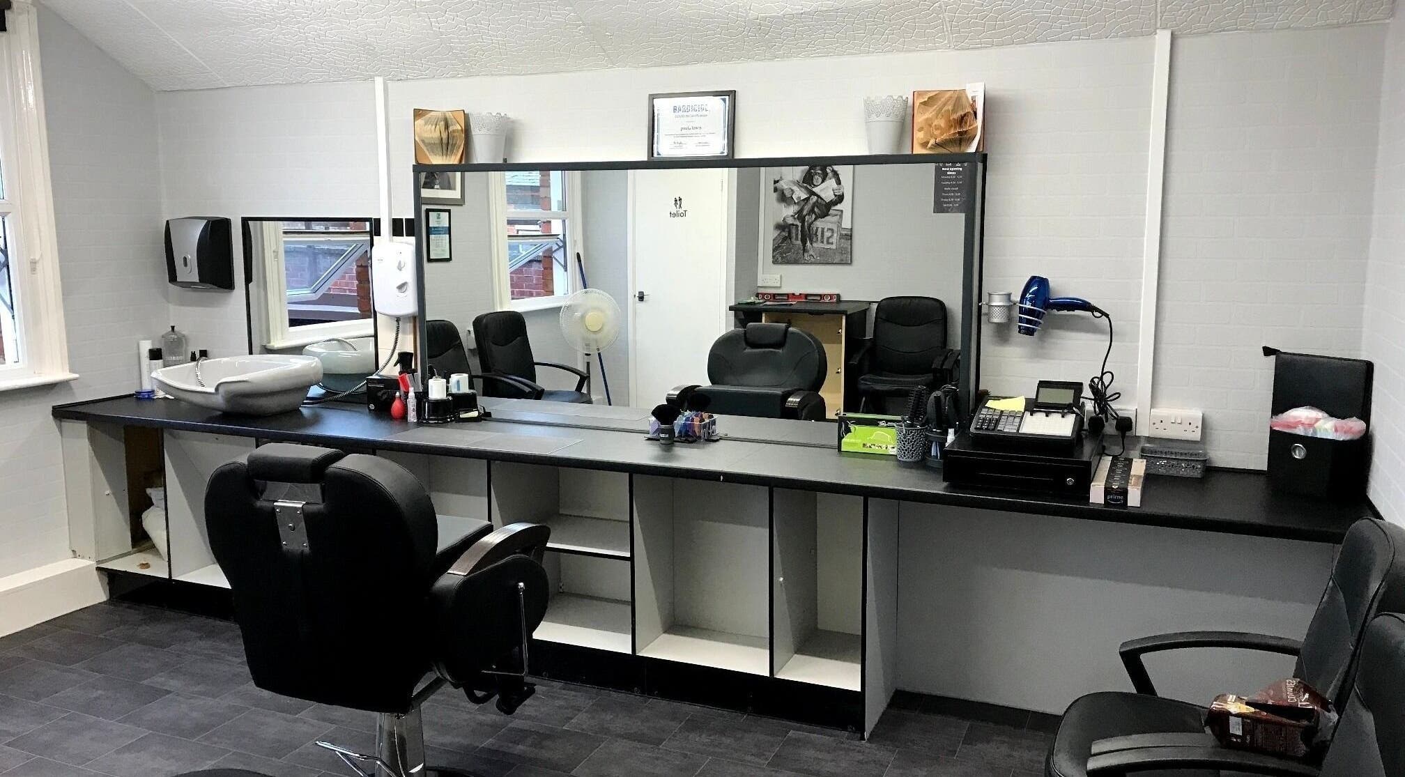 Contemporary barber chairs and stations at 3 Of A Kind Barbers in Malvern, England, GB offering stylish grooming.