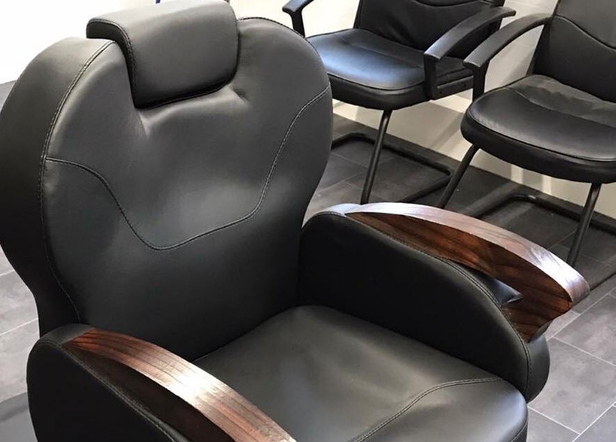 Comfortable leather barber chairs at 3 Of A Kind Barbers, Malvern, England, GB.