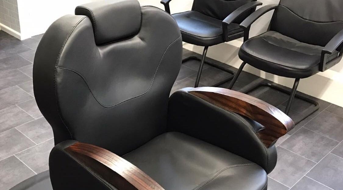 Comfortable leather barber chairs at 3 Of A Kind Barbers, Malvern, England, GB.