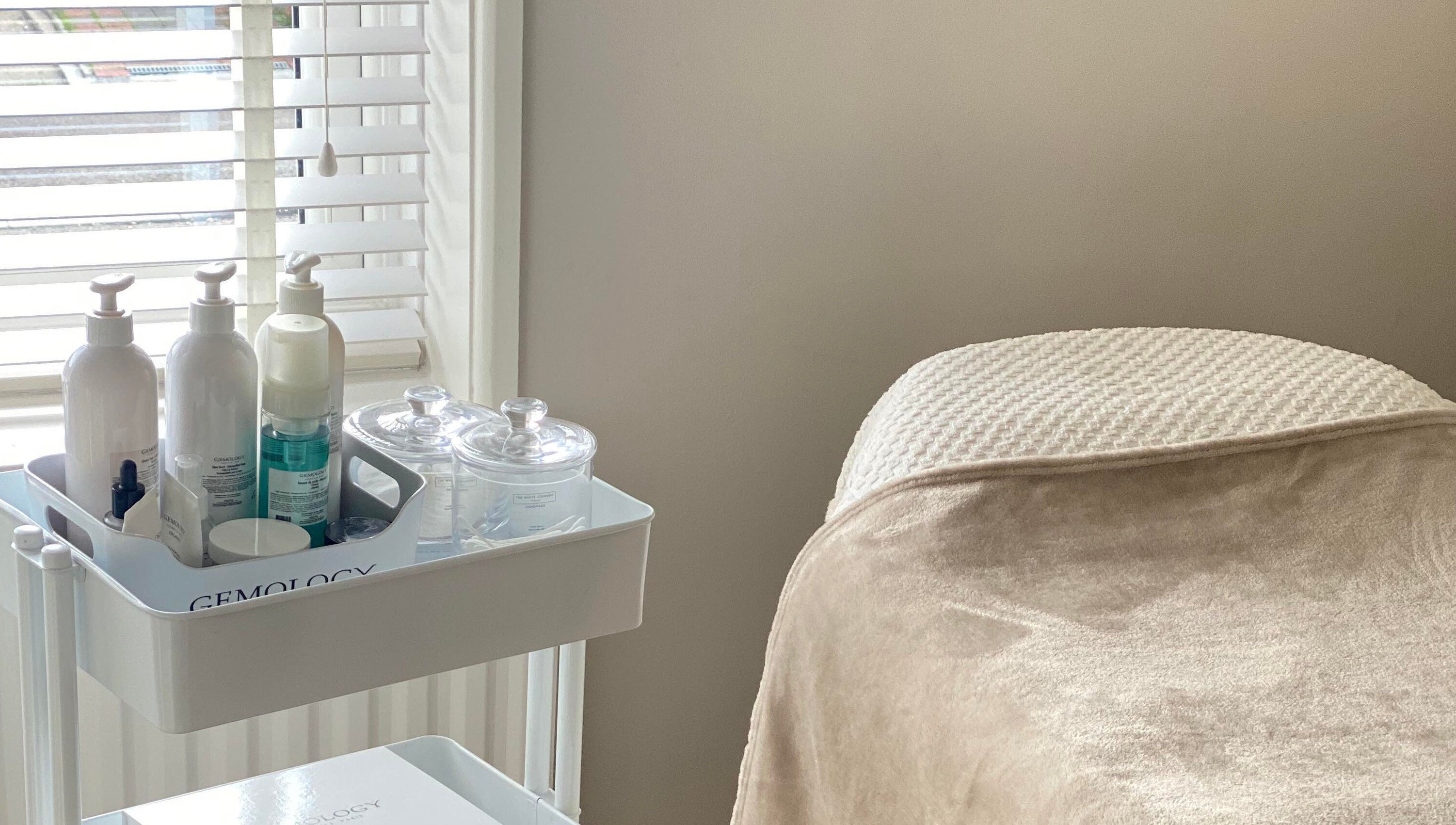 Relaxing treatment bed and product cart at Victoria Mac Skin, Carshalton, England, GB offering serene wellness.