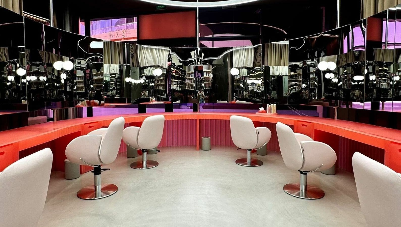 Stylish salon interior at Base & Boon - Diplomatic Quarter, Riyadh, SA with modern chairs and sleek mirrors.