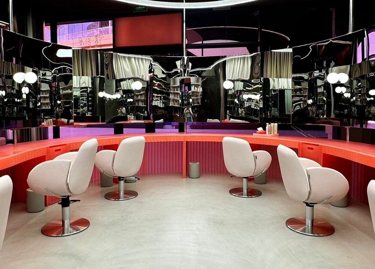 Stylish salon interior at Base & Boon - Diplomatic Quarter, Riyadh, SA with modern chairs and sleek mirrors.