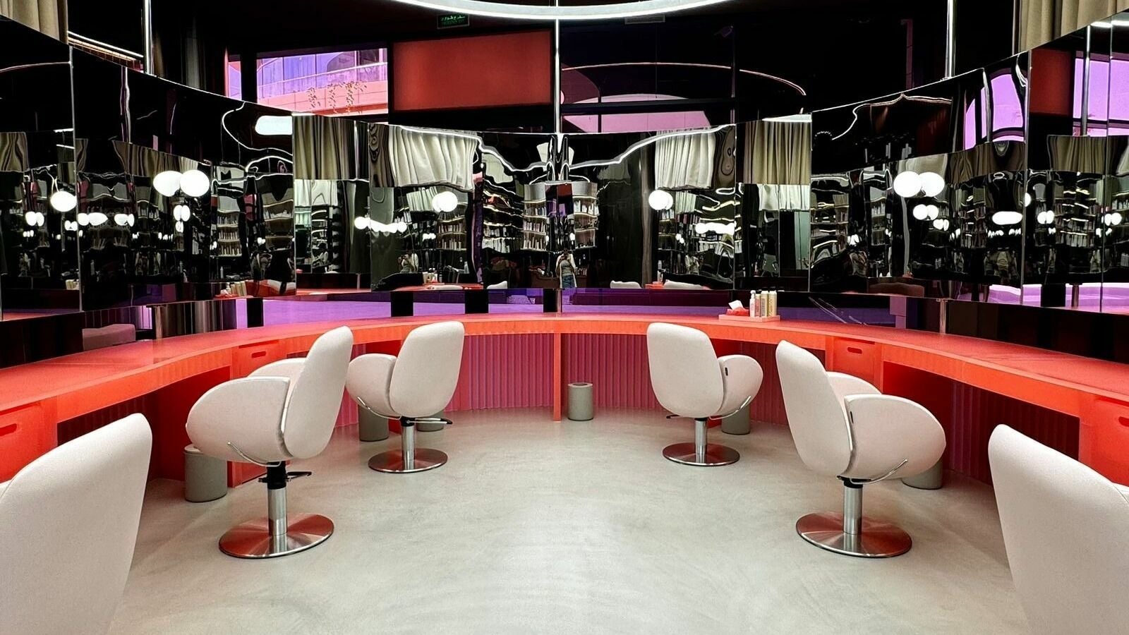 Stylish salon interior at Base & Boon - Diplomatic Quarter, Riyadh, SA with modern chairs and sleek mirrors.