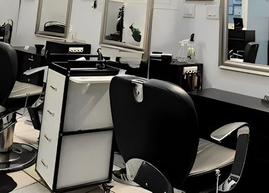 Interior view of Crissel New York Hair Salon in Brooklyn, New York, US featuring modern salon chairs and mirrors.