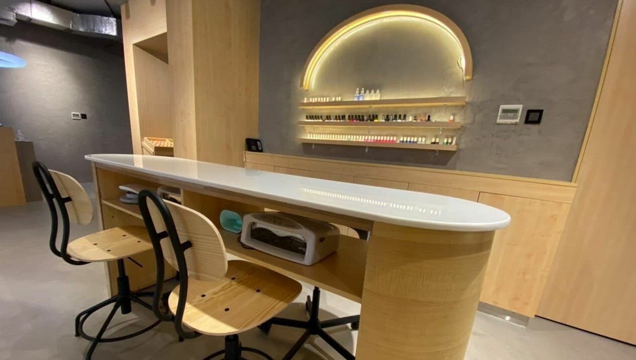Chic nail bar at Raw Beauty Salon in Abu Dhabi, AE featuring elegant chairs and modern styling.