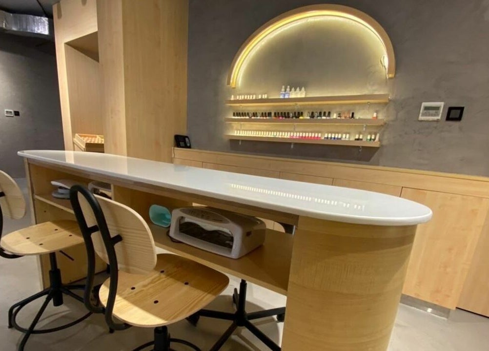 Chic nail bar at Raw Beauty Salon in Abu Dhabi, AE featuring elegant chairs and modern styling.